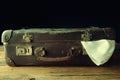 Vintage suitcase on wooden floor Royalty Free Stock Photo