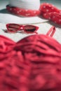 Vintage summer hat, red sunglasses and swimsuit displayed on white carpet floor. Royalty Free Stock Photo