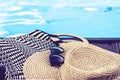 Vintage summer wicker straw beach bag, sun glasses, hat near swimming pool, tropical background Royalty Free Stock Photo