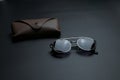 vintage sunglasses with brown case on gray background