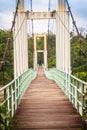 Vintage suspension bridge hanging across the river. Old lengthy Royalty Free Stock Photo