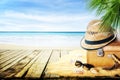 Vintage suticase, sunglasses and hipster hat on sand with seashells with blur seaside background. Summer paradise tropic travel Royalty Free Stock Photo