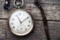 Vintage swiss pocket watch with a leather strap on the wooden boards Royalty Free Stock Photo