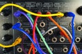 Vintage synthesizer with colorful patch cables