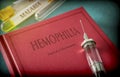 Vintage Syringe On A Book Of Hemophilia