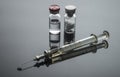 Vintage syringe next to vials with medication, conceptual image Royalty Free Stock Photo