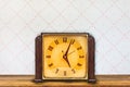 Vintage table clock in front of retro wallpaper Royalty Free Stock Photo