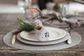 Vintage table setting, antique rustic napkin on dish and cutlery on the wooden background, close-up Royalty Free Stock Photo