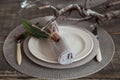 Vintage table setting, antique rustic napkin on dish and cutlery on the wooden background, top view Royalty Free Stock Photo