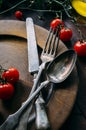 Vintage table setting with old silver spoon, fork and knife in dark wooden plate from above. Creative thanksgiving dinner still Royalty Free Stock Photo