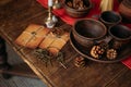 Vintage table setting with rustic ceramic cups, old keys, paper envelopes, and pine cones on a wooden surface Royalty Free Stock Photo