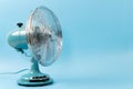 Vintage tabletop fan isolated on a blue background