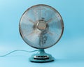 Vintage tabletop fan isolated on a blue background