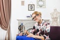 Vintage tailor dressmaker in her studio