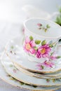Vintage Tea Or Coffee Cup With Gold Rim On A Stack Of Saucers. White Linen Tablecloth