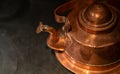 Vintage teapot or brass kettle on old gas stove. Preparing tea or coffee. Royalty Free Stock Photo