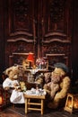 Vintage teddy bear family sitting at the tea table Royalty Free Stock Photo