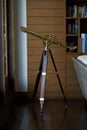 Vintage telescope in library room Royalty Free Stock Photo