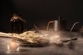 Vintage template with old metal tableware, ear of wheat and lit candles on black stone background for concept design Royalty Free Stock Photo