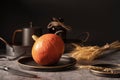 Vintage template with old metal tableware, ripe pumpkin and ear of wheat on black stone background for concept design Royalty Free Stock Photo