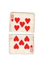 A vintage ten of hearts playing card torn in half. Royalty Free Stock Photo