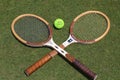 Vintage Tennis rackets and Slazenger Wimbledon Tennis Ball on grass tennis court.