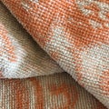 Vintage textural towel of orange color. Abstract macro shot. Royalty Free Stock Photo