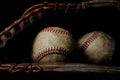 Baseball glove holding old balls closeup