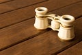 Vintage theatre binoculars on an old wooden table