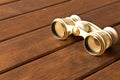 Vintage theatre binoculars on an old wooden table