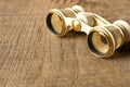 Vintage theatre binoculars on an old wooden table