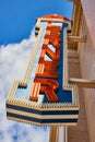 Vintage Theatre Marquee Sign in Bright Red with Light Bulbs Against Blue Sky