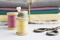 Vintage thread spools, scissors, cotton fabrics and pins Royalty Free Stock Photo