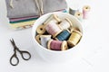 Vintage thread spools, scissors and cotton fabrics Royalty Free Stock Photo