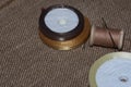 vintage threads on wooden spools and needle of beige color against a light Broun background