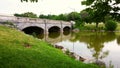 Vintage three arch bridge and woodland lake