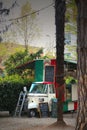 Vintage three-wheeled Piaggio Ape vehicle used as food truck plant in a park