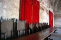 Vintage throne room interior with old wooden seats and long wooden table Royalty Free Stock Photo