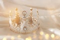 Vintage tiara over white delicate silk. Wedding concept