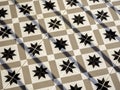 Vintage tile floor pattern with black, white and beige colors. Royalty Free Stock Photo