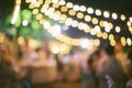 Vintage tone blur image of food stall at night festival with bokeh for background usage. Festival Event Party with People Blurred Royalty Free Stock Photo