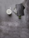 Vintage tone image of coffee with cactus, glasses and laptop on grey concrete table