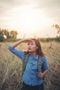 Vintage tone images of beautiful young hipster woman with backpack walking on meadow. Portrait of hiker girl outdoor. Royalty Free Stock Photo