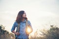 Vintage tone images of beautiful young hipster woman with backpack walking on meadow. Portrait of hiker girl outdoor. Royalty Free Stock Photo