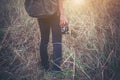 Vintage tone images of beautiful young hipster woman with backpack walking on meadow. Portrait of hiker girl outdoor. Royalty Free Stock Photo