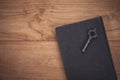 Vintage tone of key and opened book on wooden table.