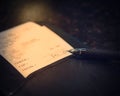 Vintage tone leather holder with restaurant bill check and pen Royalty Free Stock Photo