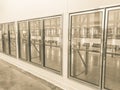 Vintage tone row of empty commercial fridges at wholesale big-box store Royalty Free Stock Photo