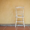 Vintage tone of white Vintage chair near yellow old wall Royalty Free Stock Photo