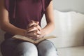 Vintage tone of woman hands on bible. she is reading and praying Royalty Free Stock Photo